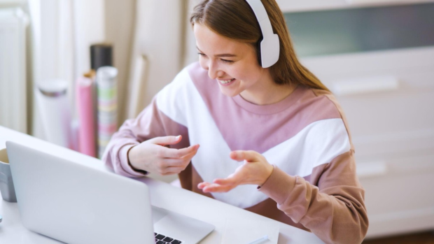 Student participating in an online lesson using a laptop
