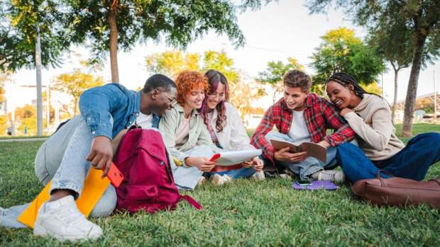 Students studying and learning together outdoors on campus
